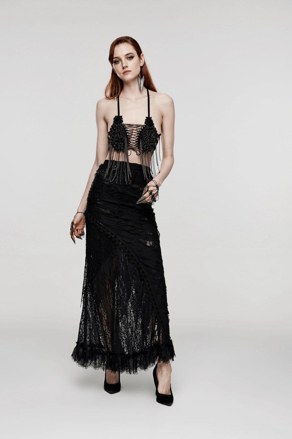 Full body front view of model wearing gothic finger hand chain paired with black gothic gown, complete alternative fashion styling