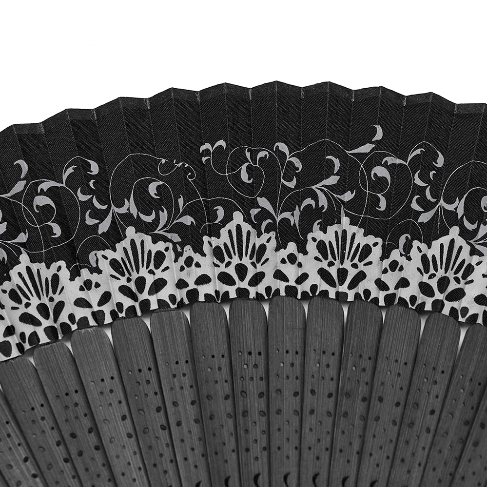 Close-up detail of black lace carved pattern on gothic hand fan edge, floral carving design with silver accents