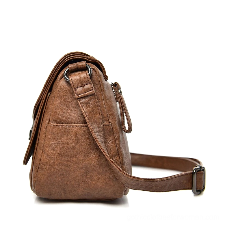 Adjustable shoulder strap of gothic leather crossbody handbag, carrying detail