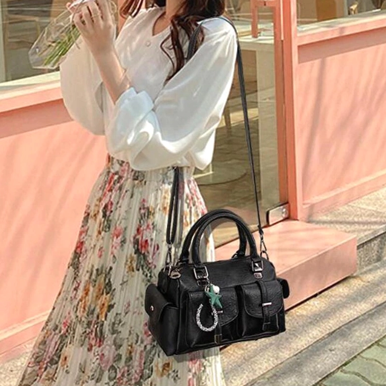 Gothic leather handbag paired with alternative fashion styling - band tee corset fishnet aesthetic