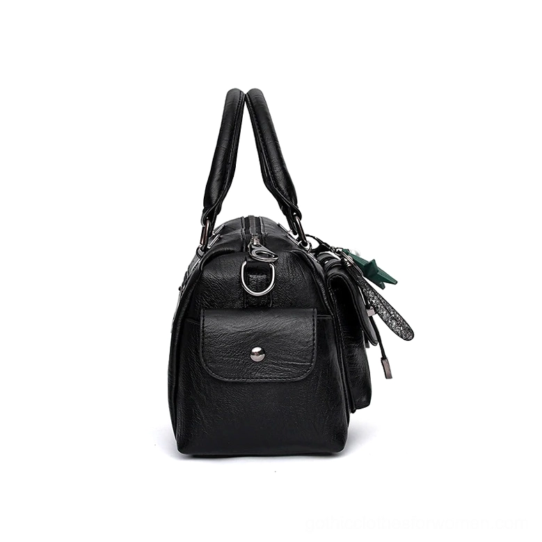 Gothic handbag adjustable shoulder strap and top handle construction showing leather quality and stitching
