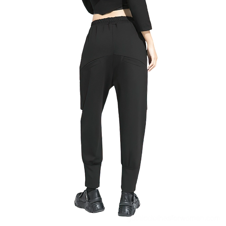 Black gothic harem trousers rear view displaying drop crotch and tapered ankles on female model