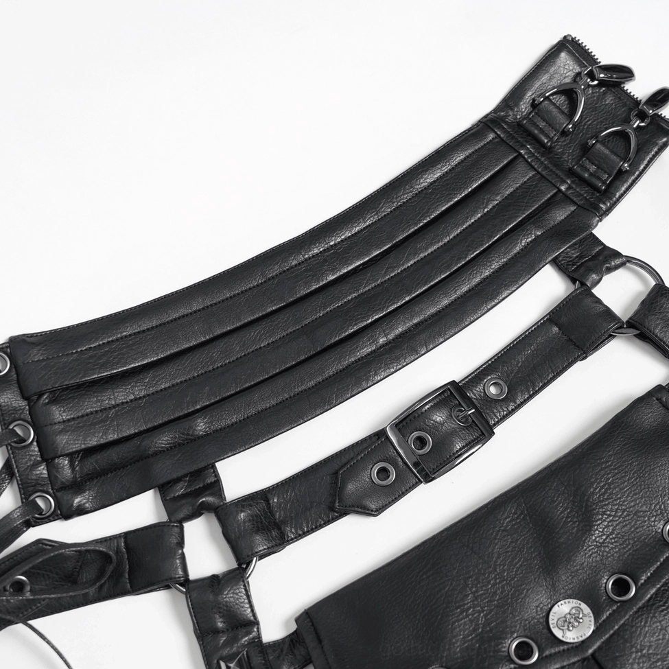 Close-up detail of black gothic harness strap showing multi-layer synthetic leather, metal fasteners and rivets