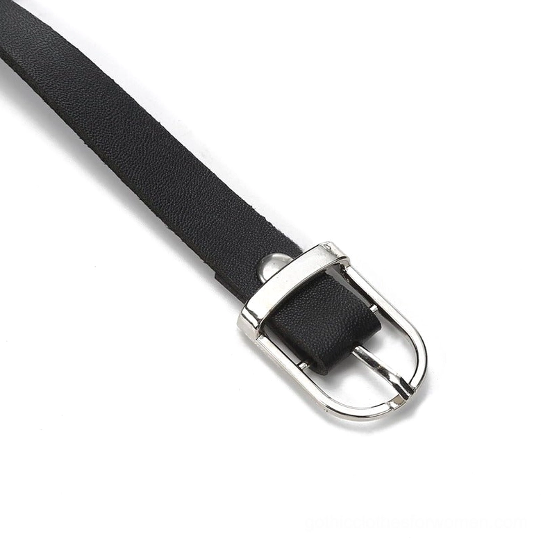 Waist harness buckle and metal hardware close-up side view, showing silver metal pin buckle and black faux leather strap attachment