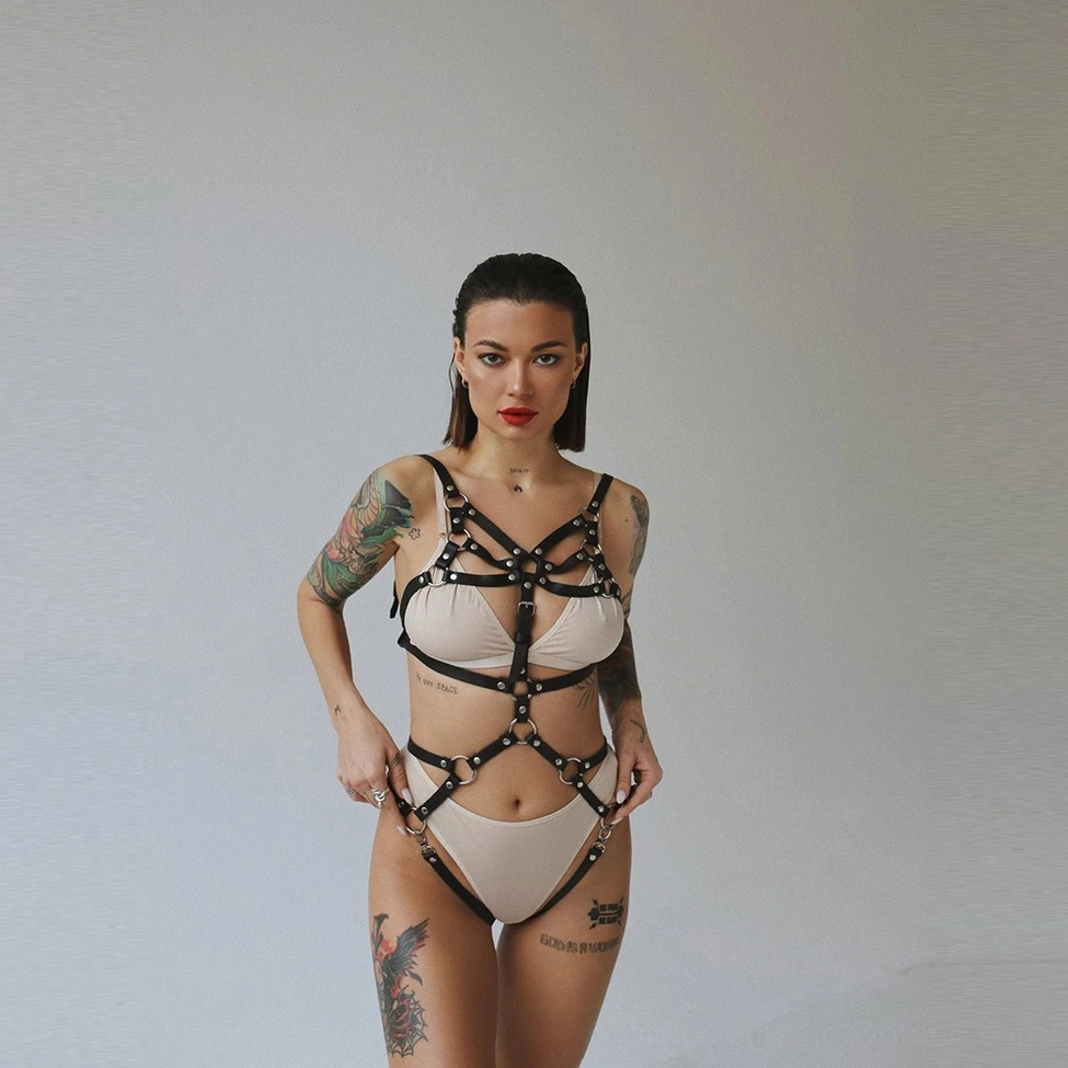 Full-body gothic harness construction detail showcasing PU material quality and metal D-ring placement