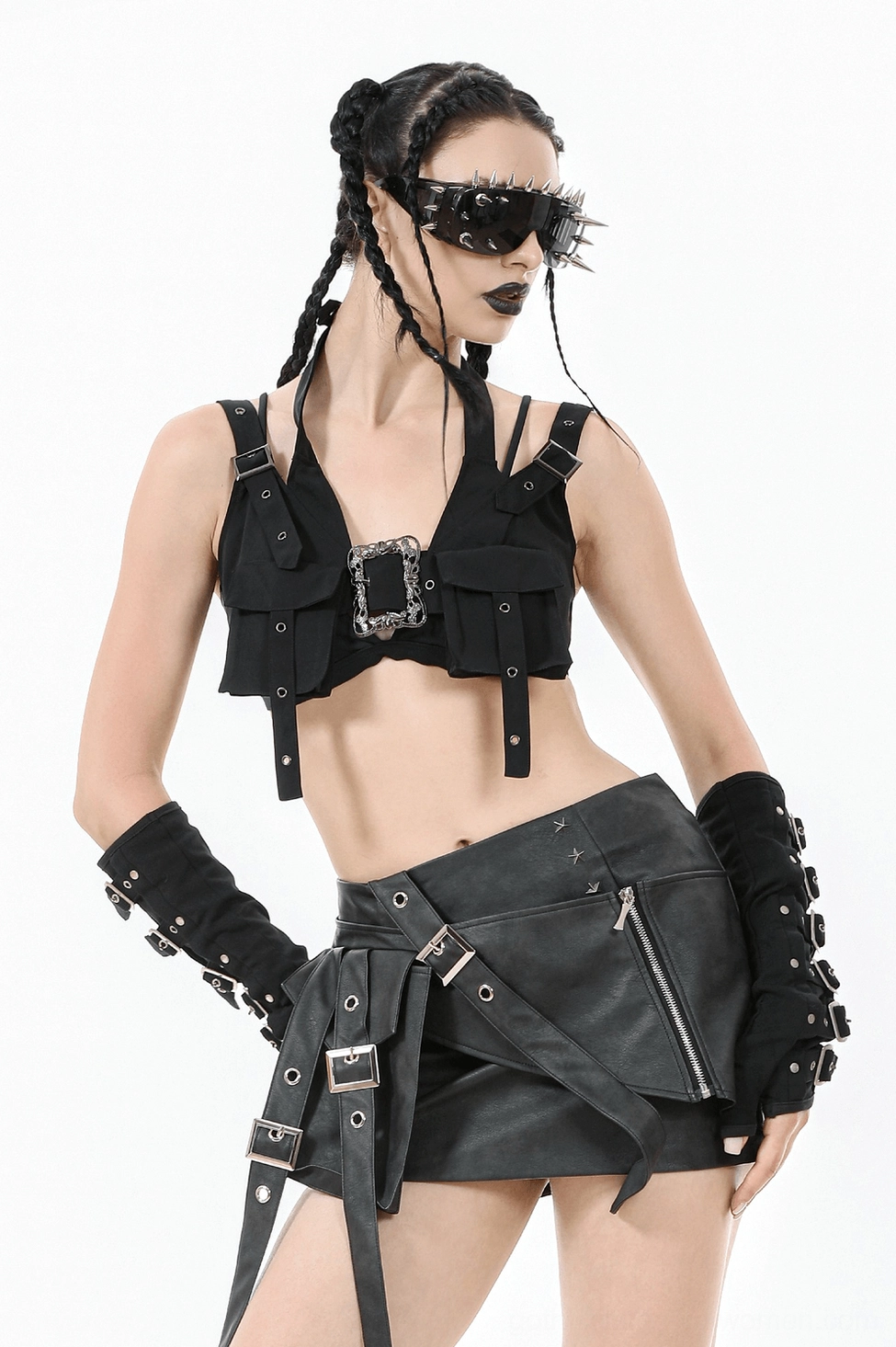 Black gothic crop top harness style featuring adjustable straps, grommet details, and structural panels creating architectural silhouette