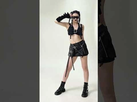 Black gothic harness crop top styled with complete biker outfit including studded gloves, combat boots, and leather mini skirt