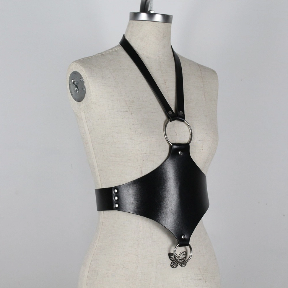 Gothic faux leather body harness close-up detail of metal hardware and leather texture