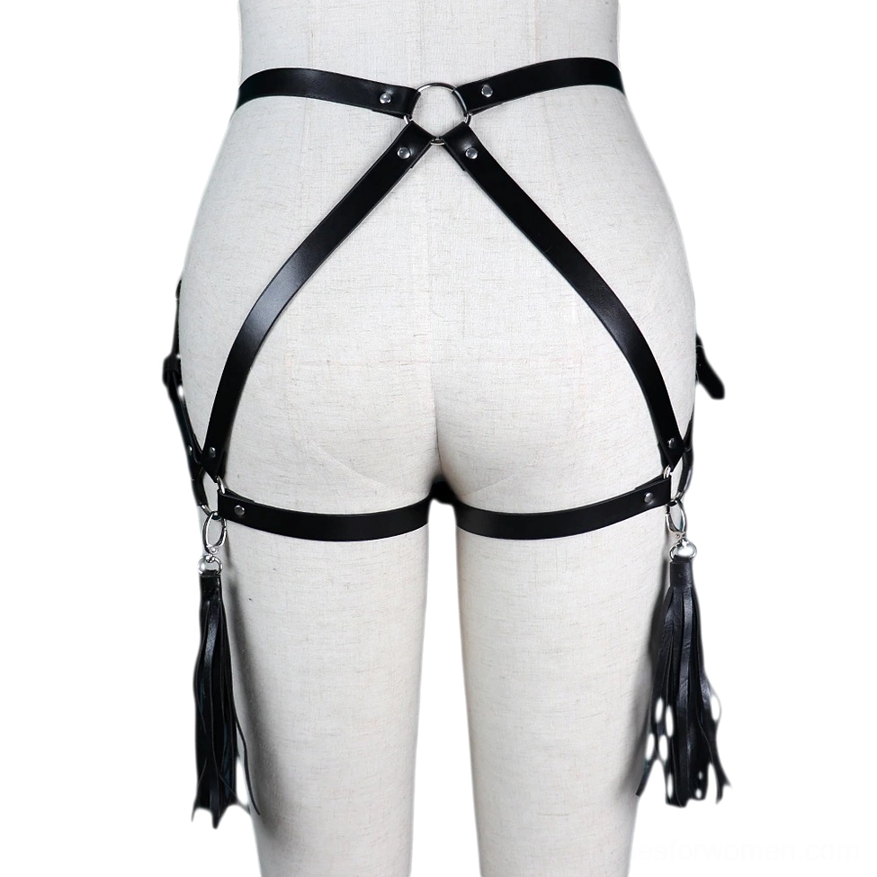 Double tassel gothic harness rear view on white mannequin torso featuring O-ring hardware, crossed black faux leather straps, and decorative tassel pendants