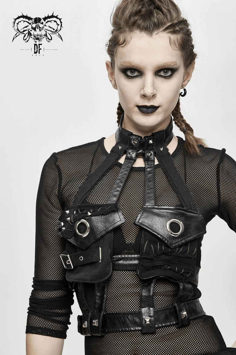 Full front view of black faux leather gothic chest harness on model in studio setting featuring metal rivet and grommet details