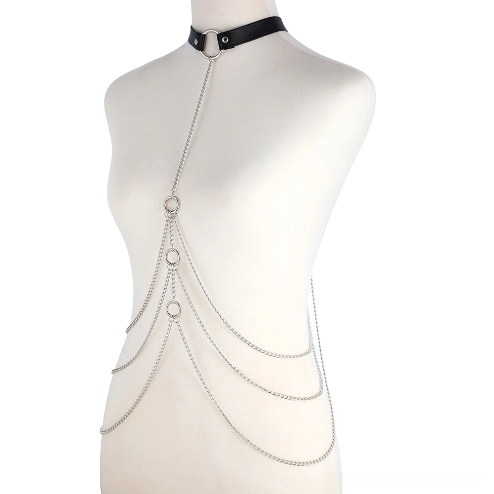 Three-quarter side view of black leather body harness with multiple layers of aluminum silver chains on female form