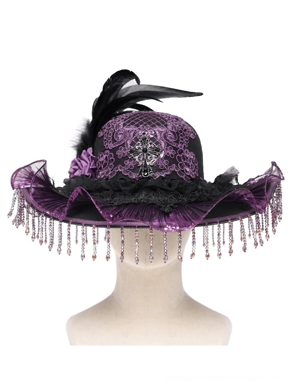 Gothic hat crown detail with cross emblem feather and beaded fringe on display