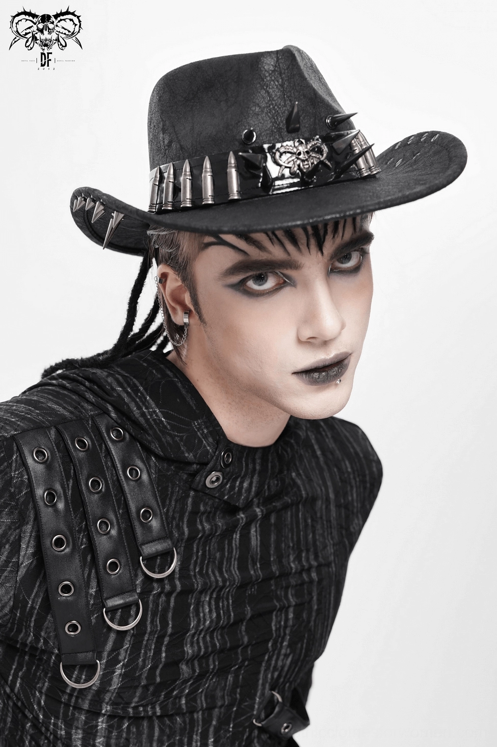 Metal spike bullet trim gothic cowboy hat lifestyle detail shot showing emblem and spike arrangement