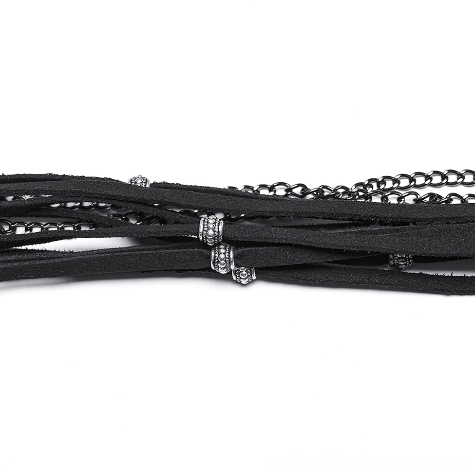 Close-up flat lay of gothic hat accessories - black leather straps, metal chains, and decorative beads