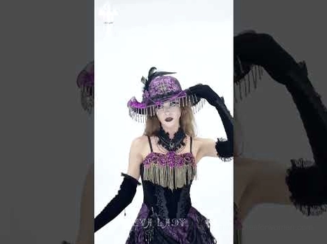 Gothic wide brim hat styled on performance model in themed setting with purple lace details