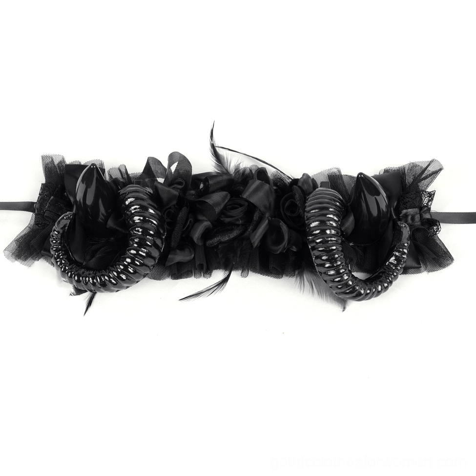Unfinished gothic headband kit flat lay with black ruffled fabric, feather trim and spiral horns components