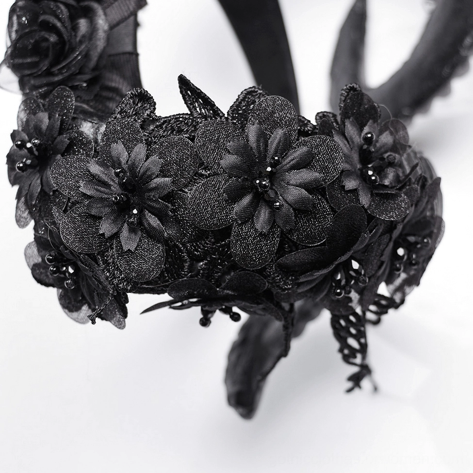 Macro close-up of black fabric flowers with beaded accents from gothic horned headpiece floral decoration