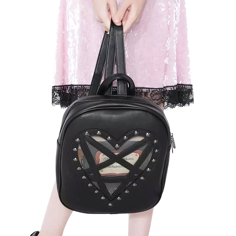 Black gothic heart transparent backpack with studded pentagram detail, hand-held front view on model in pink lace dress