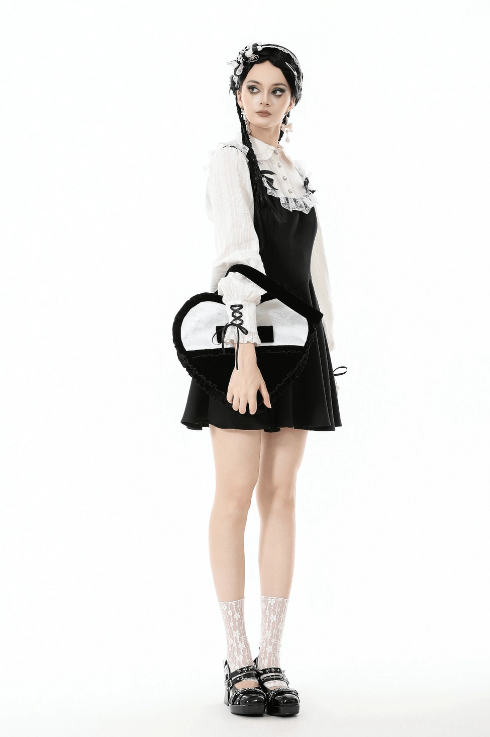 Heart-shaped gothic crossbody bag side profile showing velvet texture lace overlay and ruffled edges from alternative angle
