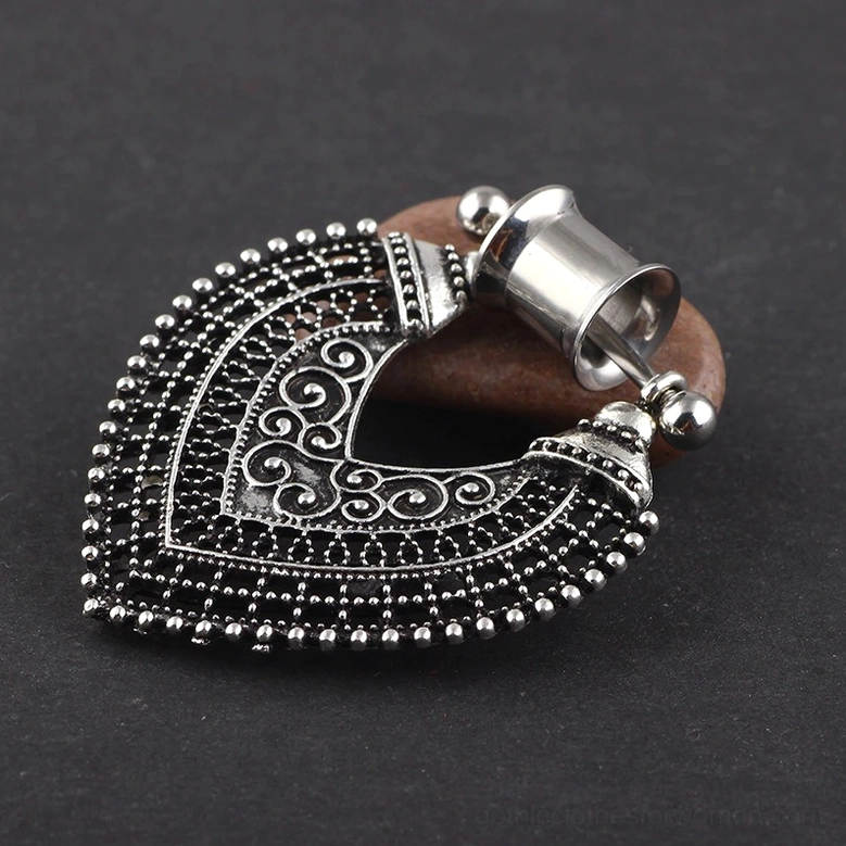 Top-down overhead view of gothic heart ear tunnel displaying hollow filigree design and beaded trim detail