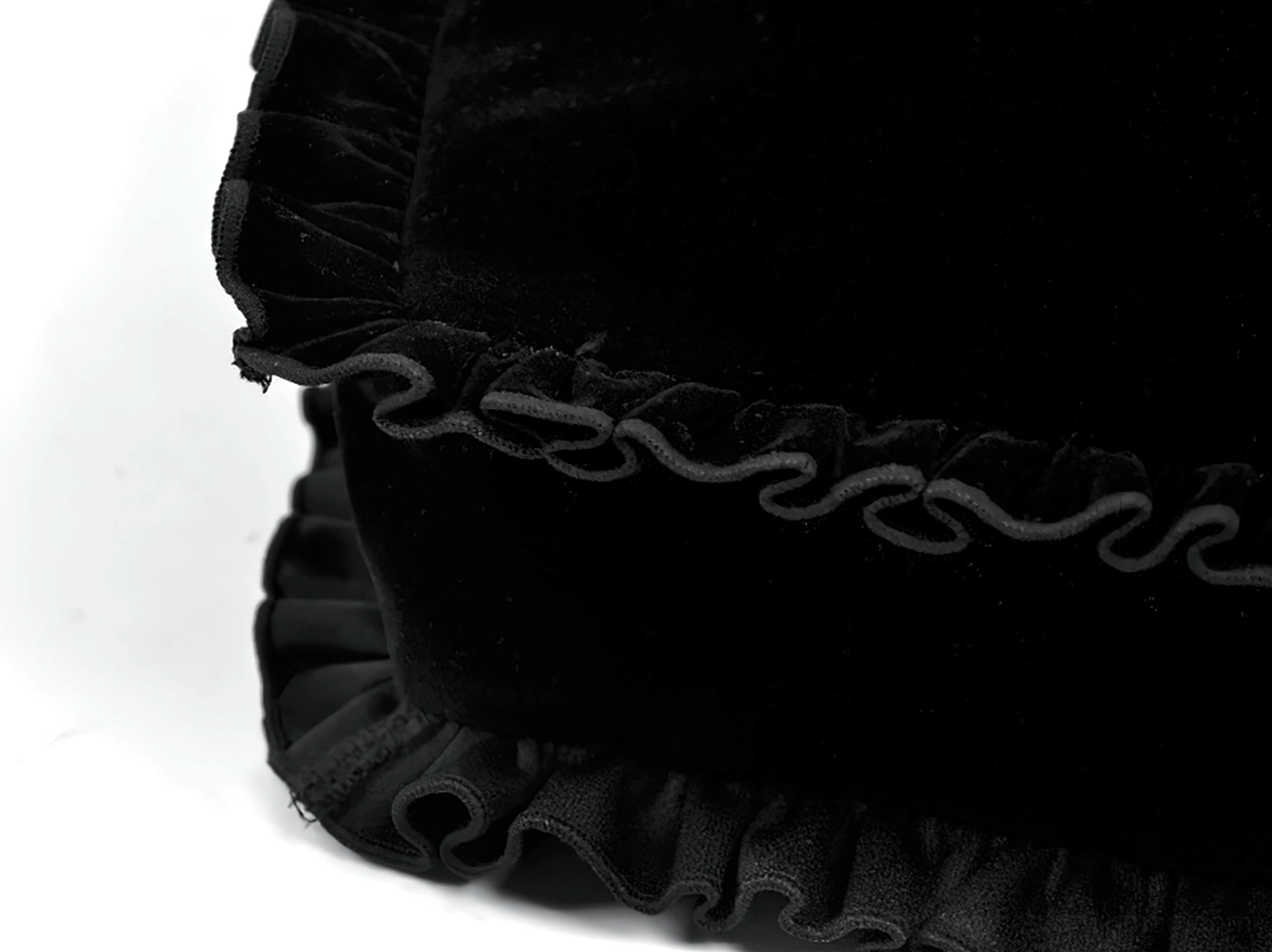 Black heart-shaped gothic crossbody bag back view showing velvet exterior and strap attachment point for carrying