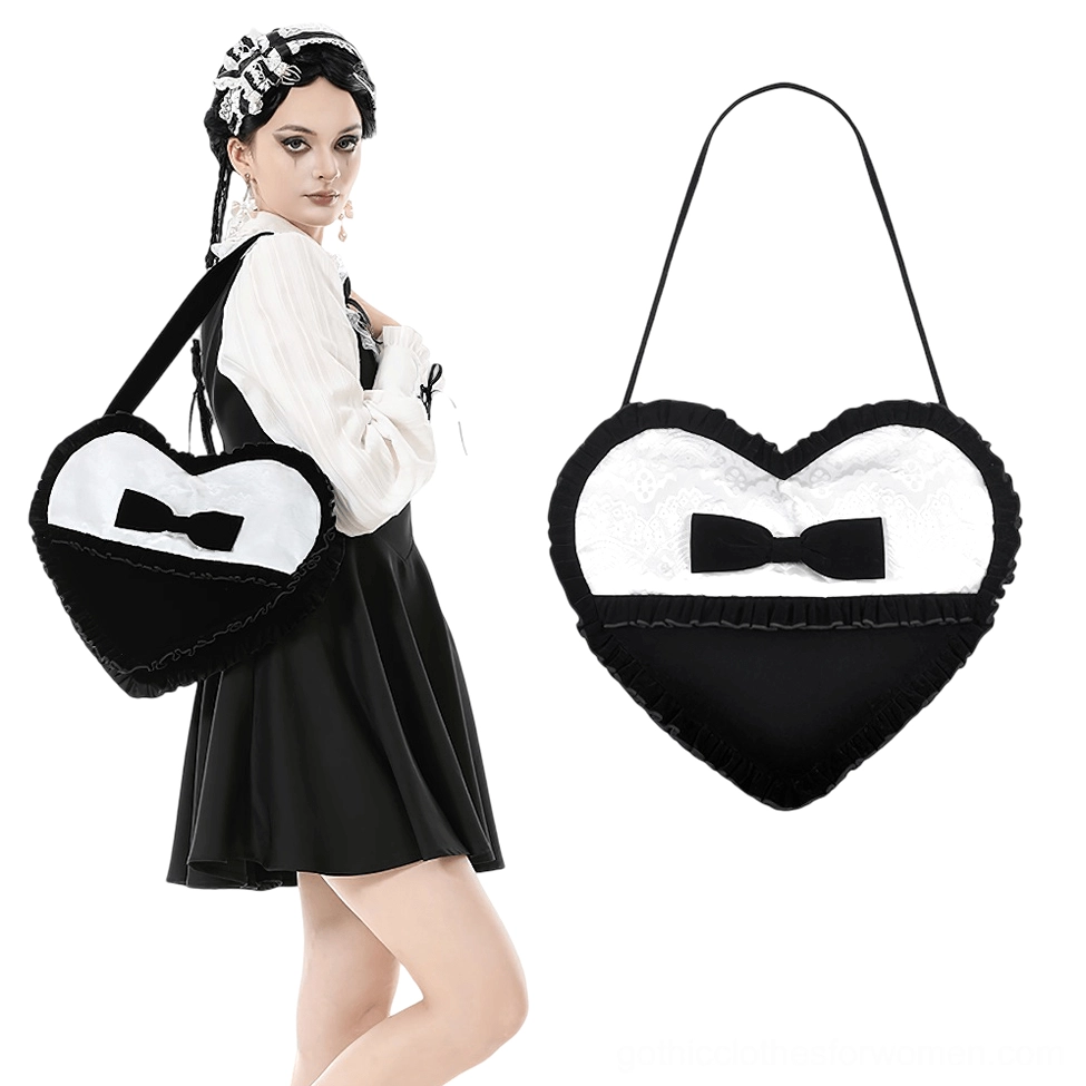 Female model wearing black heart-shaped gothic lace bow crossbody bag side front angle showing bag worn over shoulder with gothic lolita coordinate