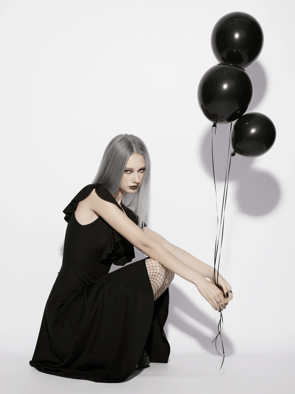 Gothic lace-up high-low dress side angle view emphasizing ruffle sleeves and dramatic silhouette