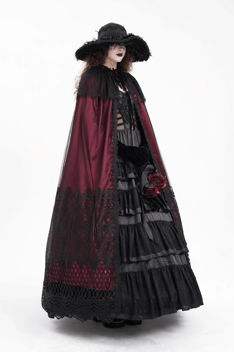 Model wearing gothic hooded cape in alternative fashion styling with full-length satin drape and mystery aesthetic