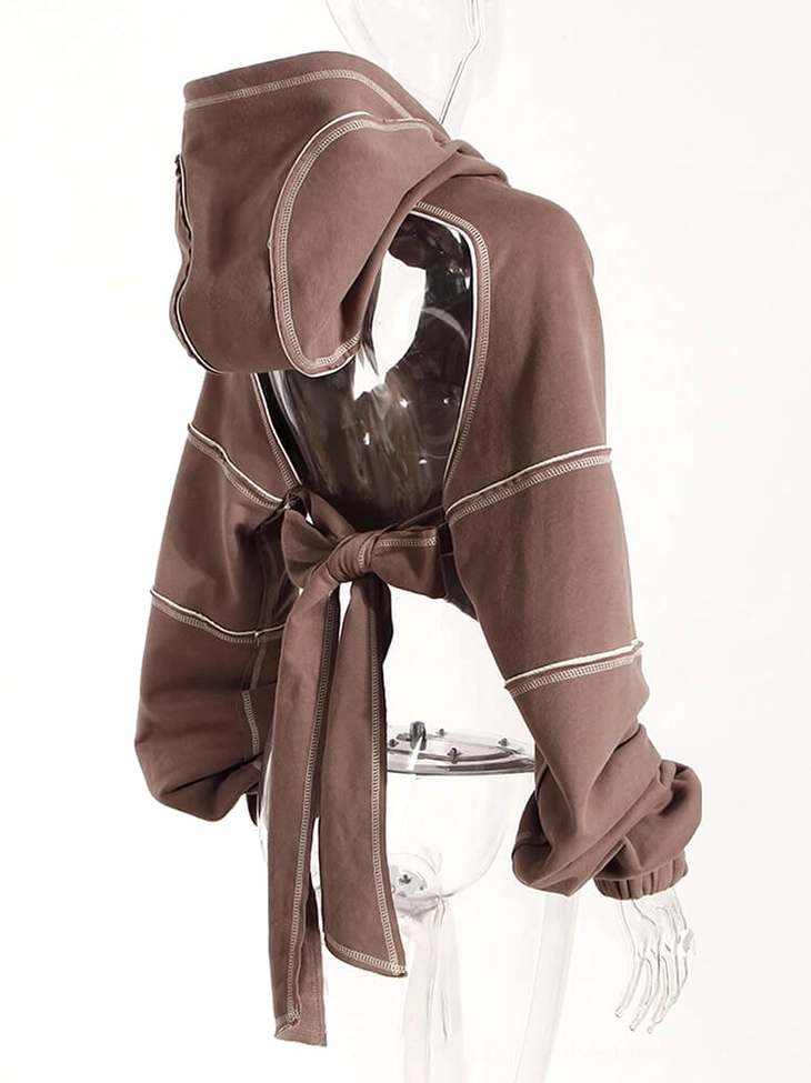 Gothic crop hoodie styling detail close-up showing hollow-out cutout craftsmanship and contrast stitching