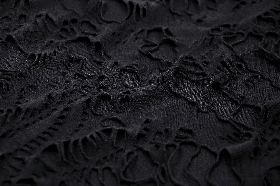 Intricate black hollow-out lace pattern texture detail on gothic ripped hoodie