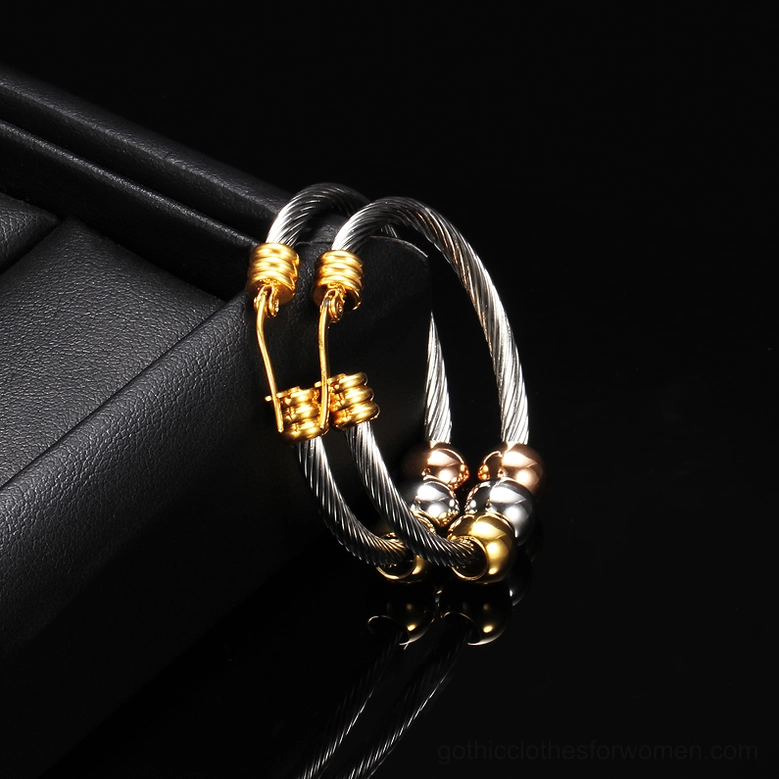 Twisted cable gothic hoop earrings close-up side view displayed in jewelry box showing stainless steel quality and gold clasps