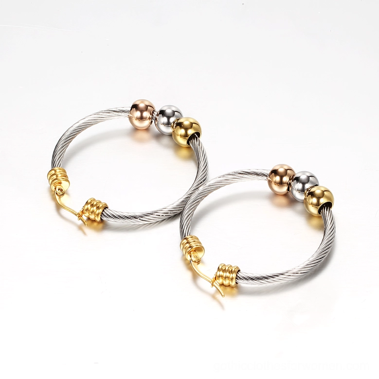 Side view of tri-color beaded twisted gothic hoop earrings on white background showcasing texture and metallic finish