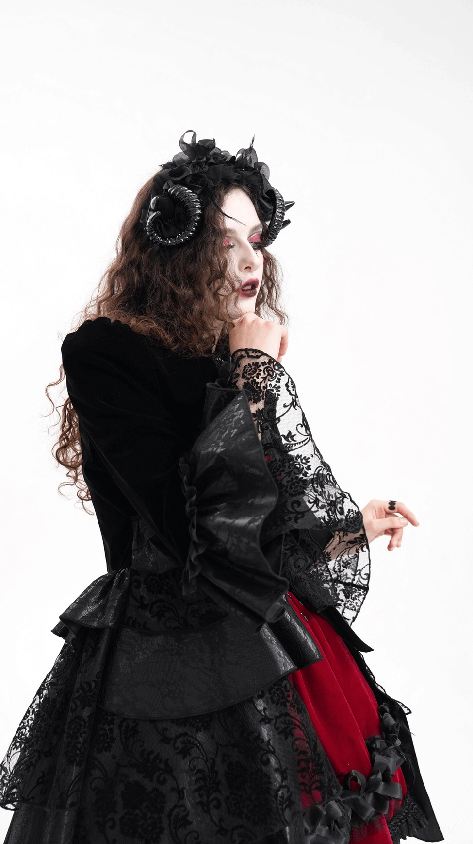 Black gothic horn headband with delicate floral embellishments and adjustable ribbon ties, close-up detail view