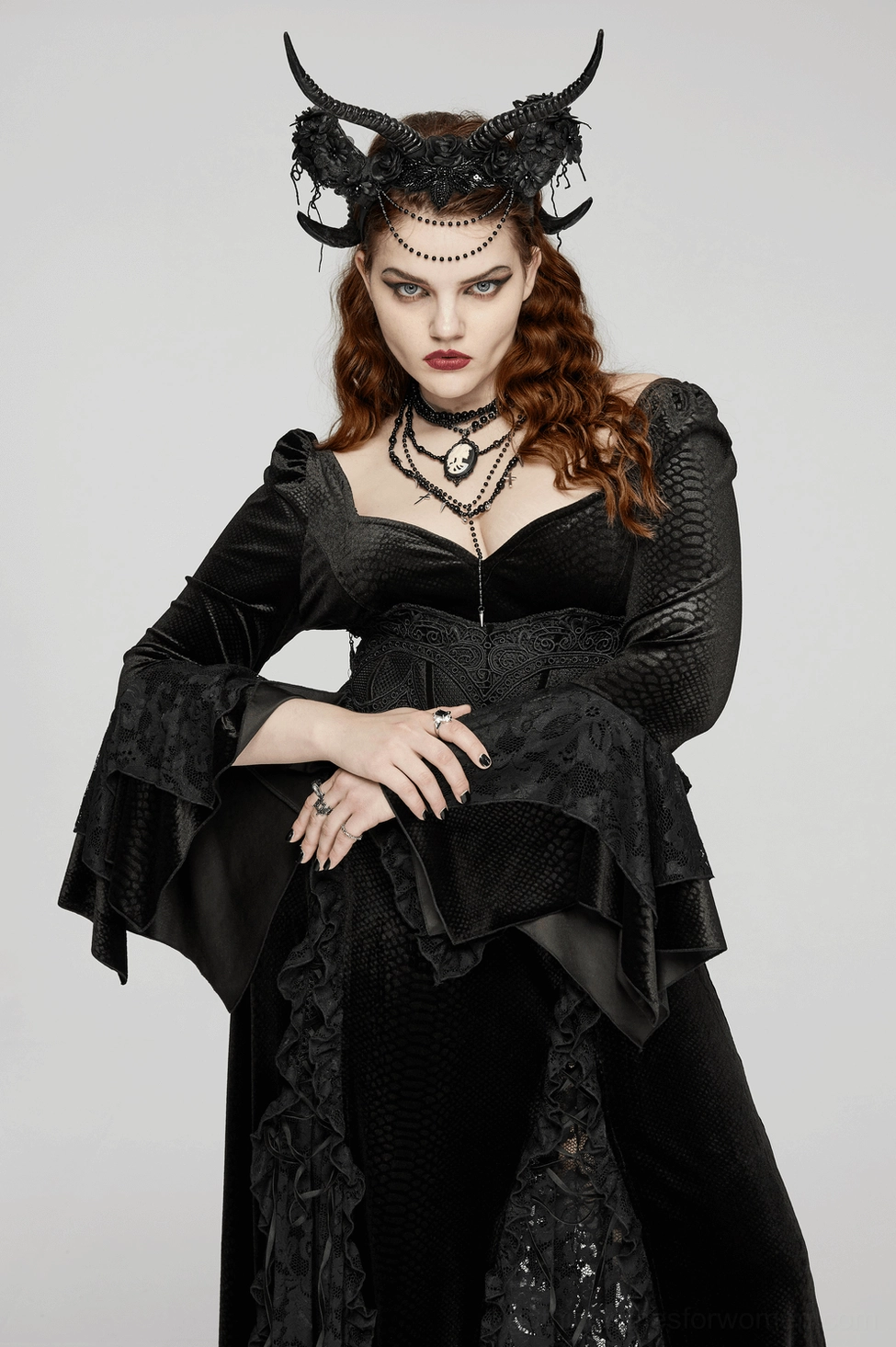 Gothic horned headpiece featuring curved black horns, lace floral decorations, and beaded chain embellishments