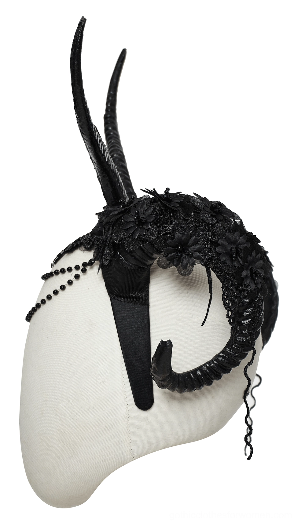 Gothic horned headpiece side rear view on display dummy showing black fabric flowers and curved horn structure