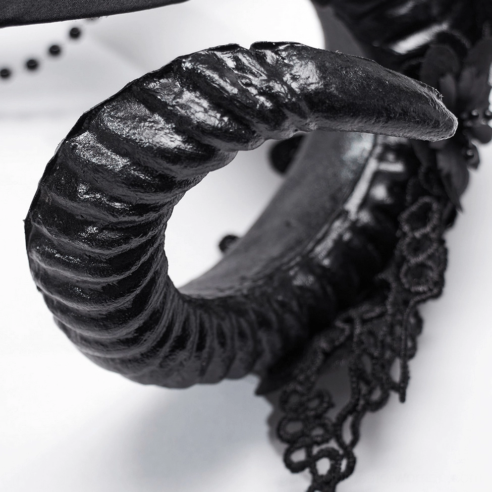Close-up detail of textured black ram horn with lace edging from gothic horned headpiece