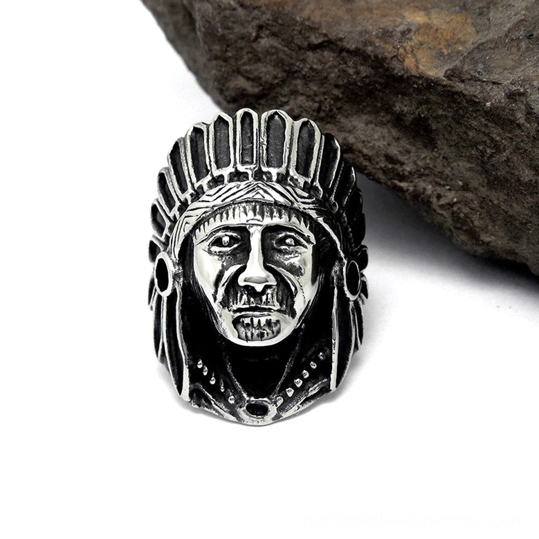 Vintage silver-black stainless steel Indian chief ring with realistic facial carving details on textured stone background