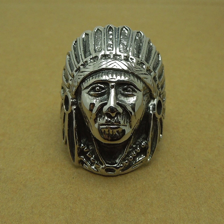 Clear detailed Indian chief carving on stainless steel ring with polished vintage silver finish against tan paper background