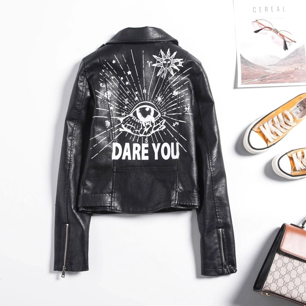 Back flat lay view of black leather jacket with iconic DARE YOU back print paired with casual lifestyle accessories