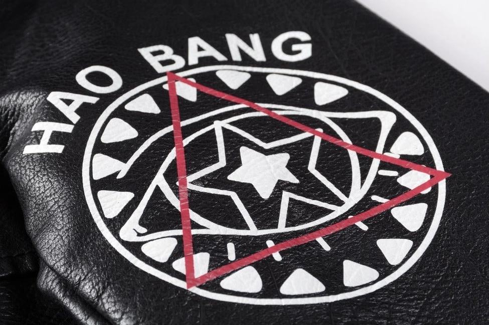 Black PU leather jacket back panel detailed view showing DARE YOU graphic studs and artistic print composition