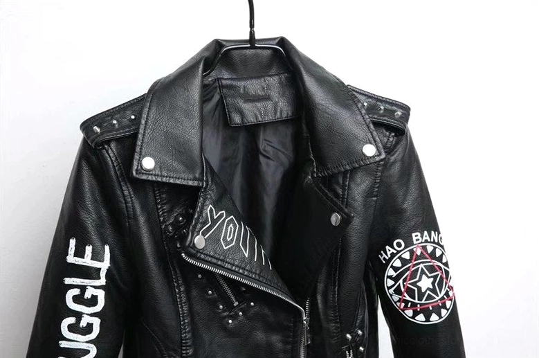 Detailed close-up of black motorcycle jacket front 3D printed graphics eye motif and stud embellishments high resolution