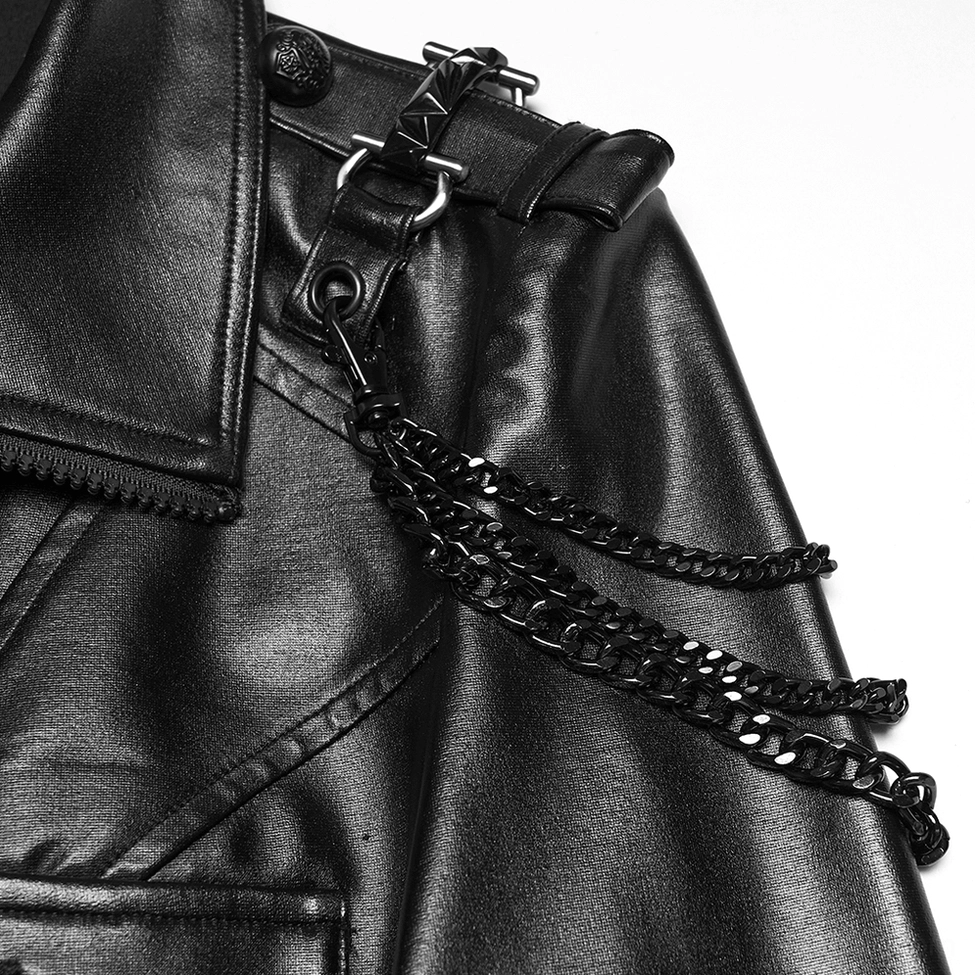 Close-up detail of black gothic jacket shoulder chain ornaments and leather strap hardware accents