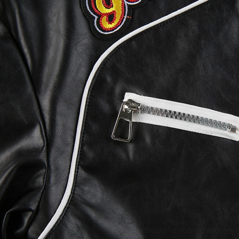 Detailed view of gothic cropped biker jacket showing stand collar, chest pockets, and monochromatic color blocking