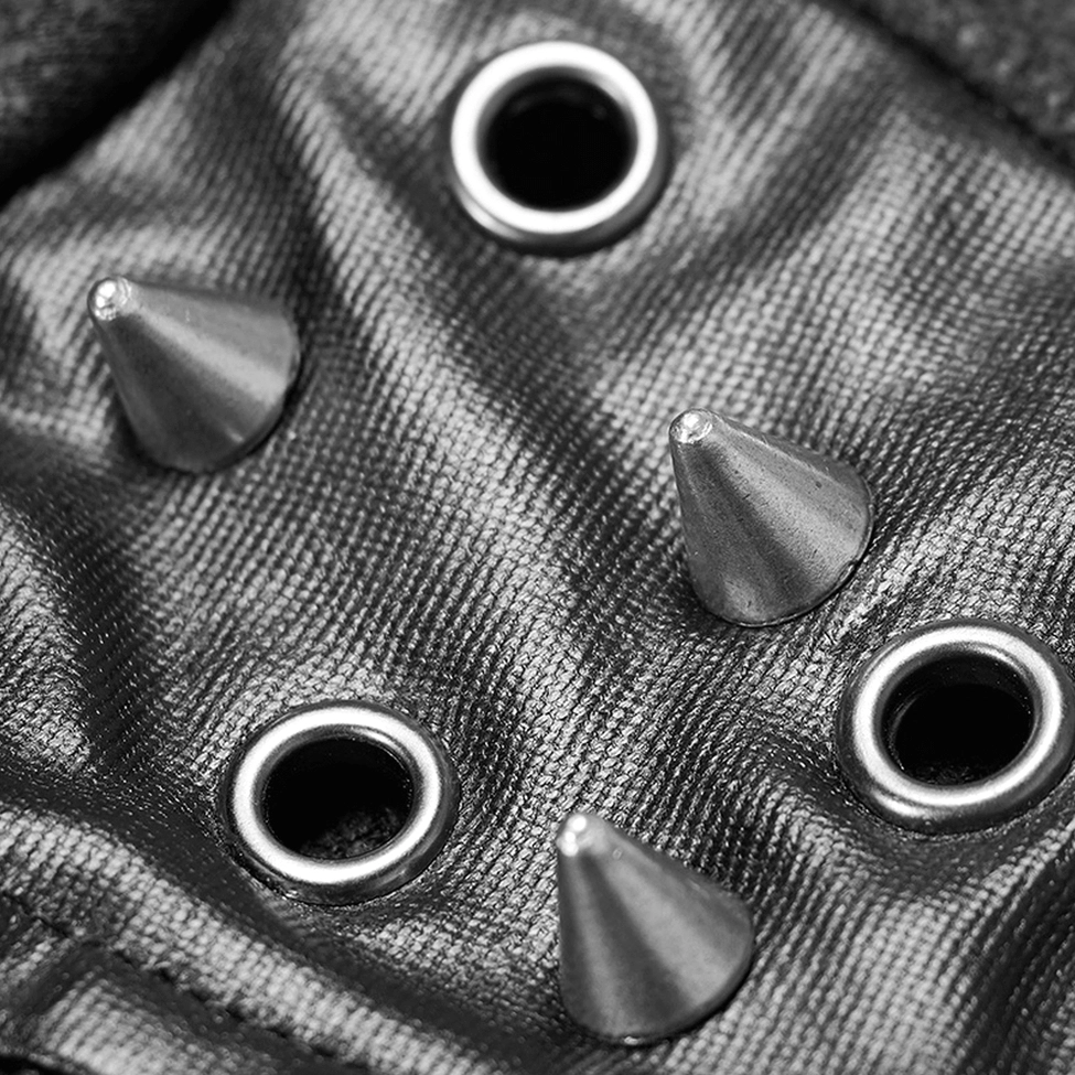 One-shoulder gothic jacket fabric texture close-up - cone studs and cracked leather detail