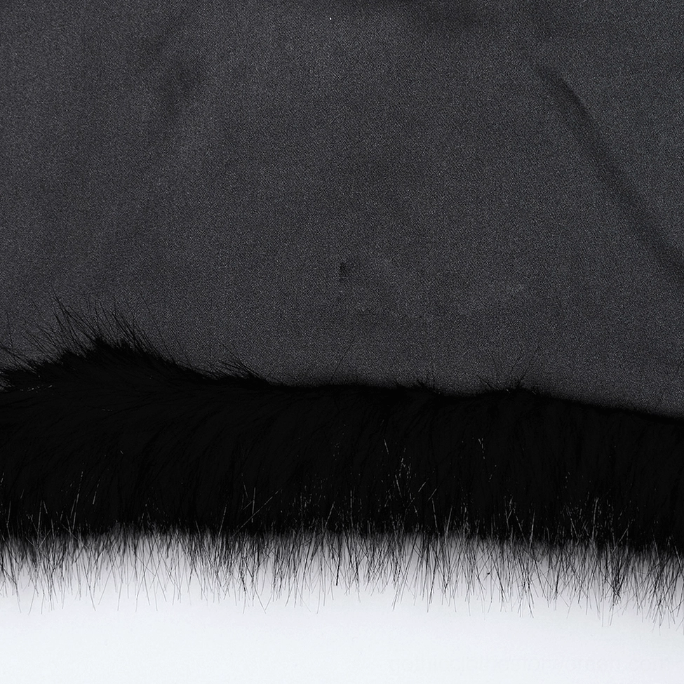 Close-up detail of black faux fur gothic jacket hem and inner lining showing fluffy faux fox fur pile texture and smooth fabric lining