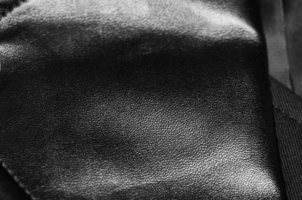 Macro photography of genuine leather texture mixing smooth matte and cracked leather panels
