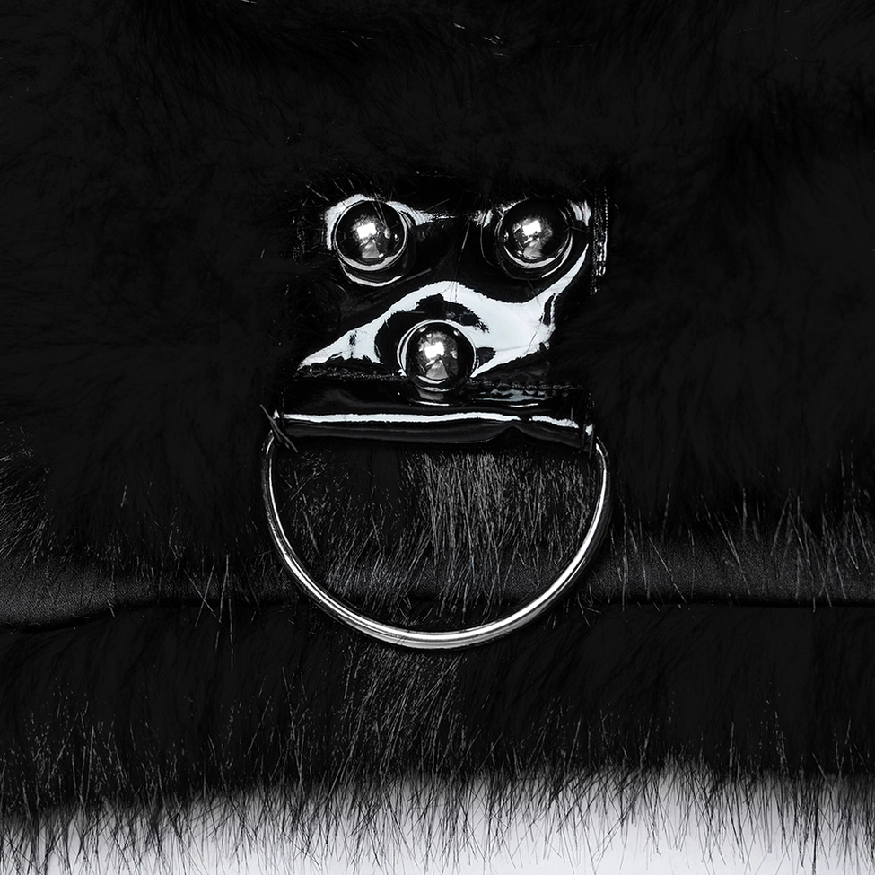 Close-up detail shot of black faux fur gothic jacket metal rivet hardware showing shiny silver rivets with hanging d-ring on faux fur