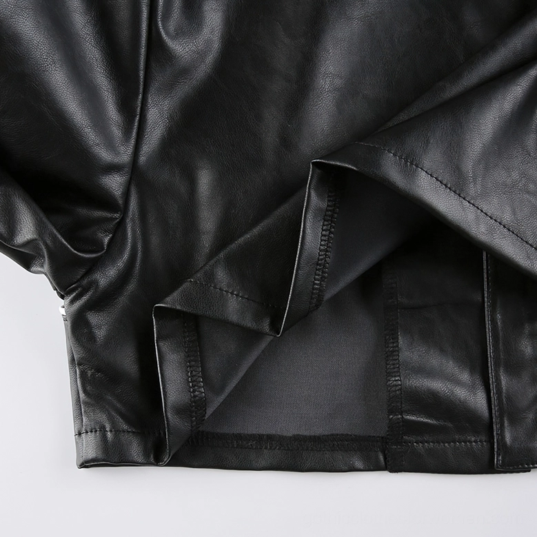 Close-up texture view of black and white gothic patchwork biker jacket showing PU leather finish and seaming