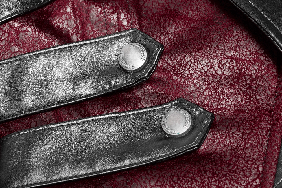 Close-up detail of black leather corset-style straps with metal snap buttons on gothic jacket sleeves