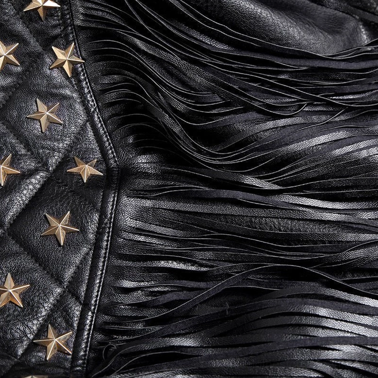 Close-up detail of gothic biker jacket tassel trim showing hanging leather fringe with quilted stitching and star studs